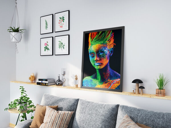 UV ışığı altında, neon yeşil, turuncu ve mavi vücut boyasıyla kaplı, gözleri ve saçları parlayan bir kişinin yakın çekim portresi.